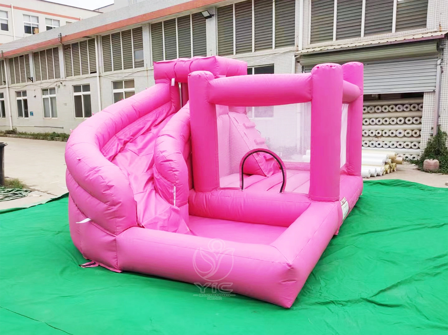 Pink bounce house with slide and ball pit