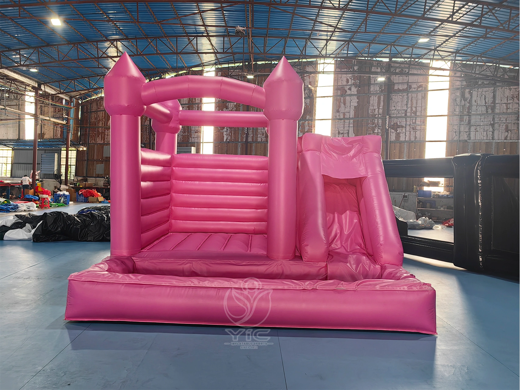 Pink bounce house with slide and ball pit